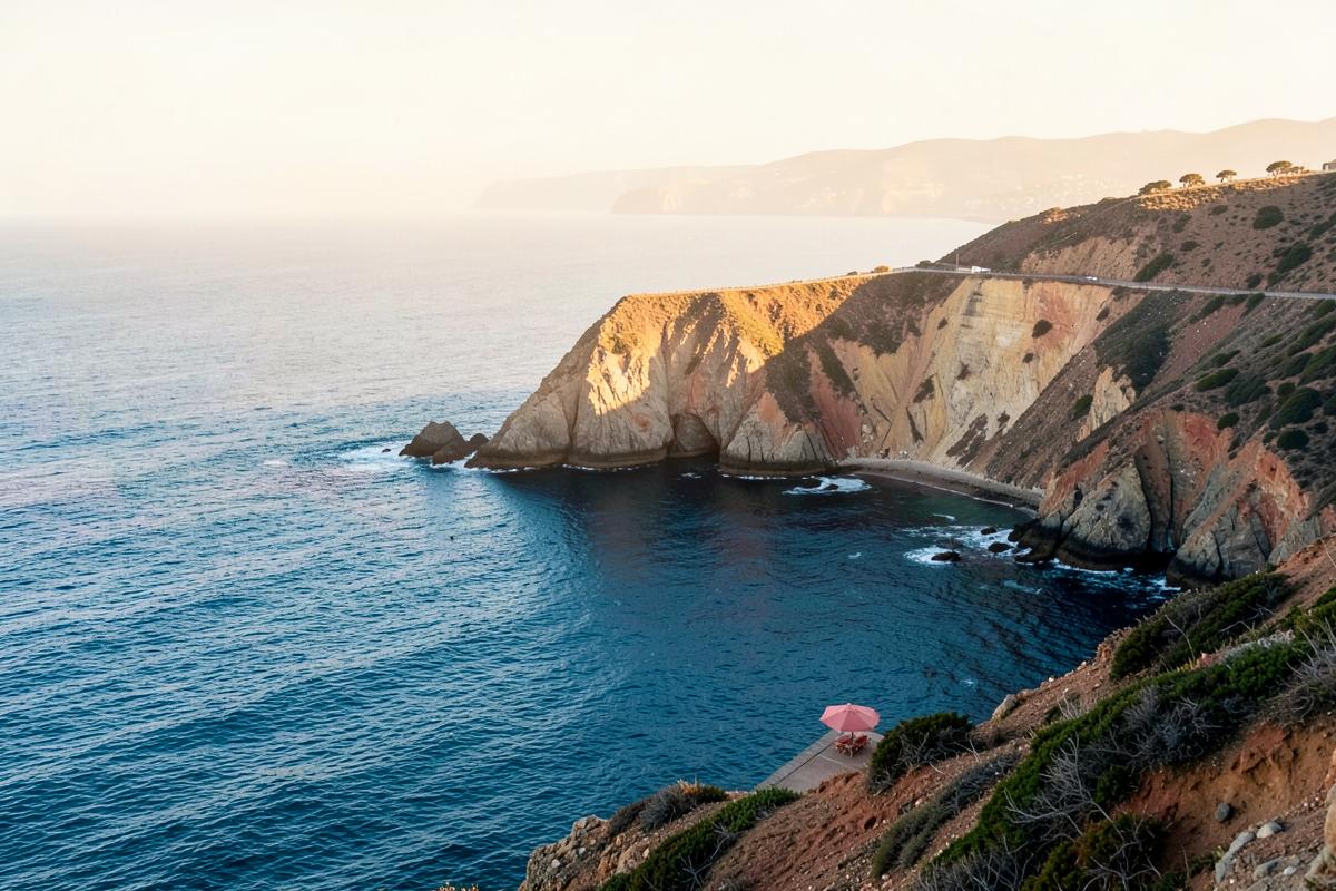 Sunlit cliffs meeting deep blue ocean along the Southern California coast